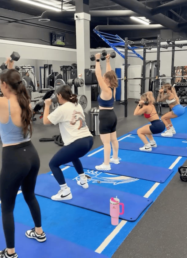 man flexing muscles in a gym